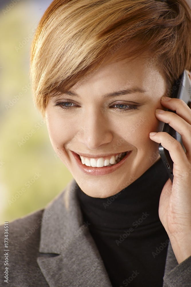 Closeup of happy young woman talking on mobile Closeup of happy young woman talking on mobile