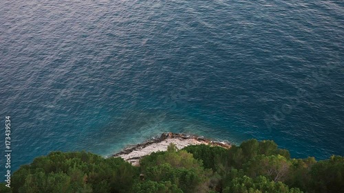 Beautiful view from the cliff mountain to the beach of Makarska through the pine forest. Dalmatia, Croatia.