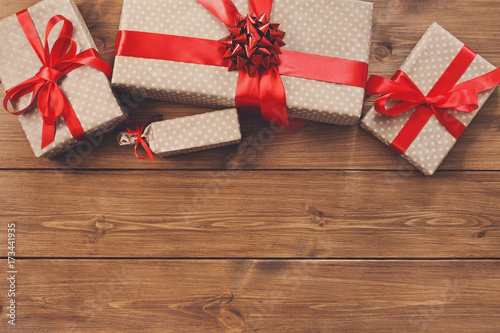 Presents in gift boxes on wood frame background