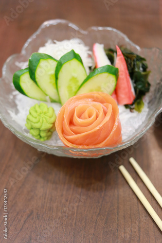 Salmon sashimi in glass bowl.