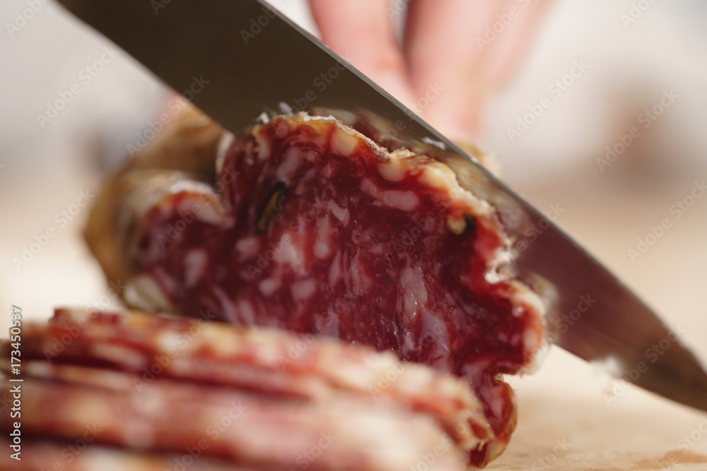 slicing italian salame close up shot slicing italian salame close up shot