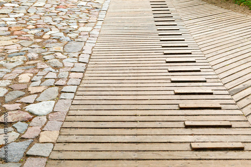 Wooden walking path is made of planks of larch
