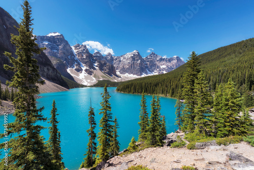 Beautiful turquoise waters of the Moraine lake with snow-covered peaks above it in Banff National Park, Canada.