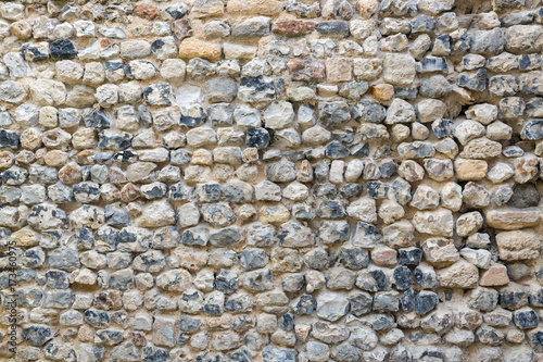 Background old brickwork with stones of different color