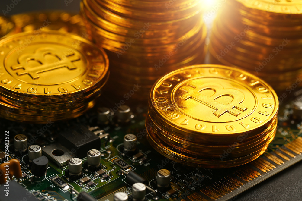 golden bitcoins on circuit board
