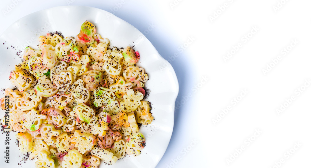 Colorful pasta with poppy seeds on a plate Colorful pasta with poppy seeds on a plate