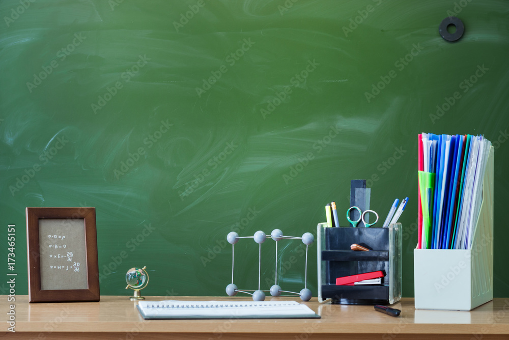 Teacher or student desk table. Education background. Education concept.  School accessories on the table. Stock Photo | Adobe Stock