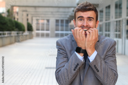 Принти на полотні Anxious businessman biting his nails isolated