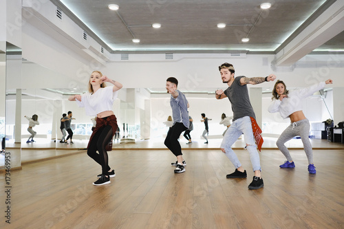 Group of young modern dancers dancing in the studio
