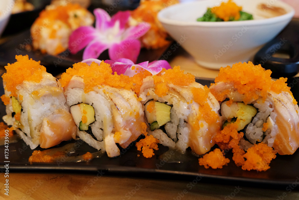 salmon sushi rolls on black dish (Salmon Sushi). selective focus.