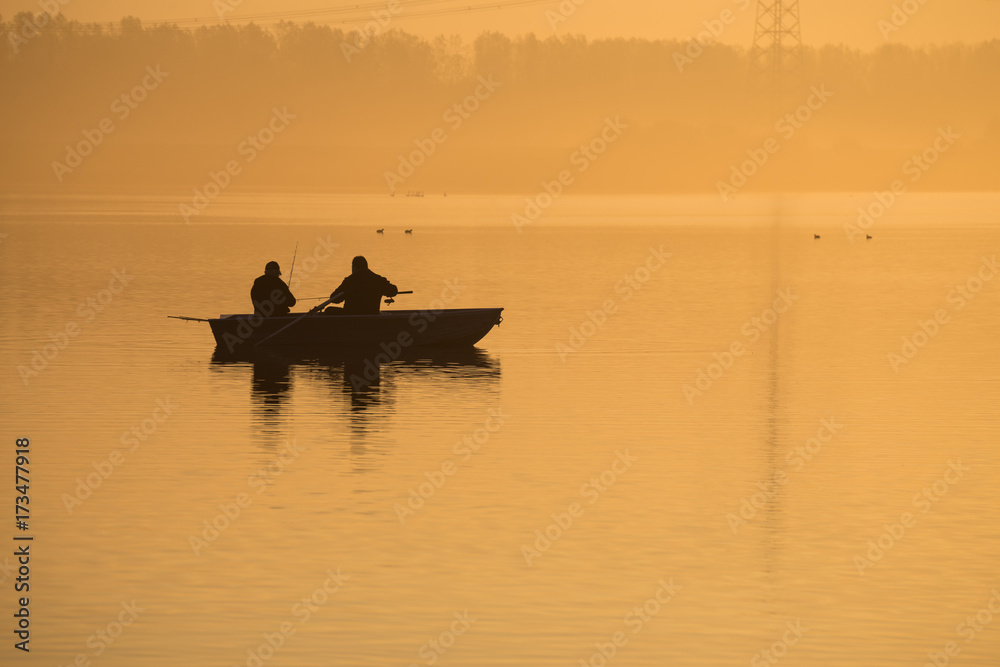 Orange sunrise on the lake. Golden autumn morning