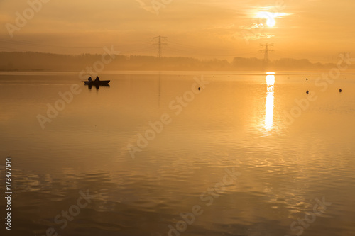 Orange sunrise on the lake. Golden autumn morning