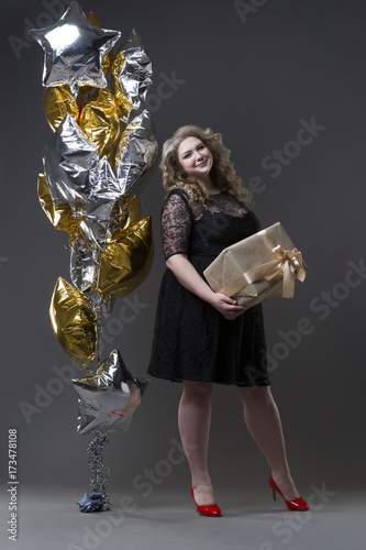 Plus size woman with gift box and balloons