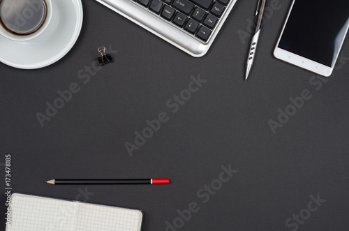 Business objects on a black desk.