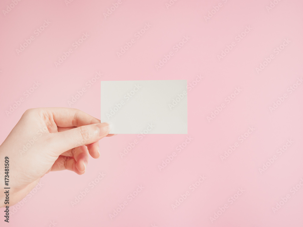 business communication concept by exchange name card to new customer by beauty asian woman left hand with pink pastel background business communication concept by exchange name card to new customer by beauty asian woman left hand with pink pastel background