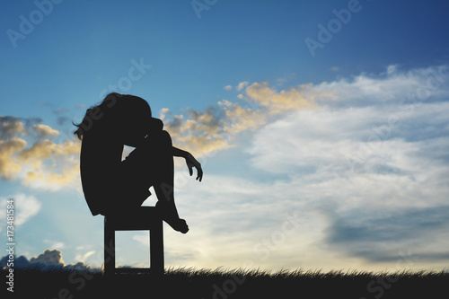 Silhouette of sad women sitting on chair felling discouraged, concept failure photo
