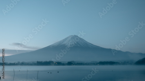 beauty night landscape view from kawaguchi lake with sky and fuji mountain range background with motion blur from group of duck from japan