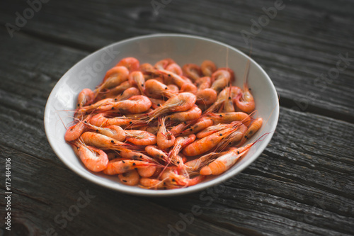 on a white plate on wooden background shrimp