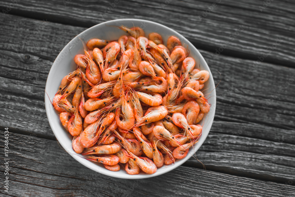 on a white plate on wooden background shrimp on a white plate on wooden background shrimp