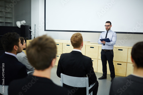 Confident speaker listening to feedback of audience after lecture or master-class