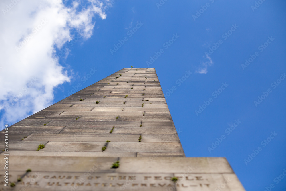 Perspective view from below of an obelisk in a cloudy sky Perspective view from below of an obelisk in a cloudy sky