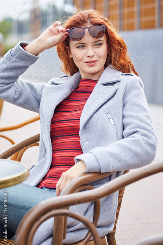 Autumn redhead woman in city break