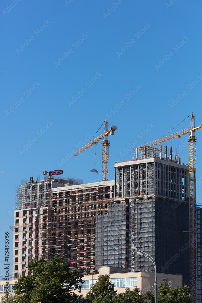 High-rise construction. Construction cranes. Crane arm.