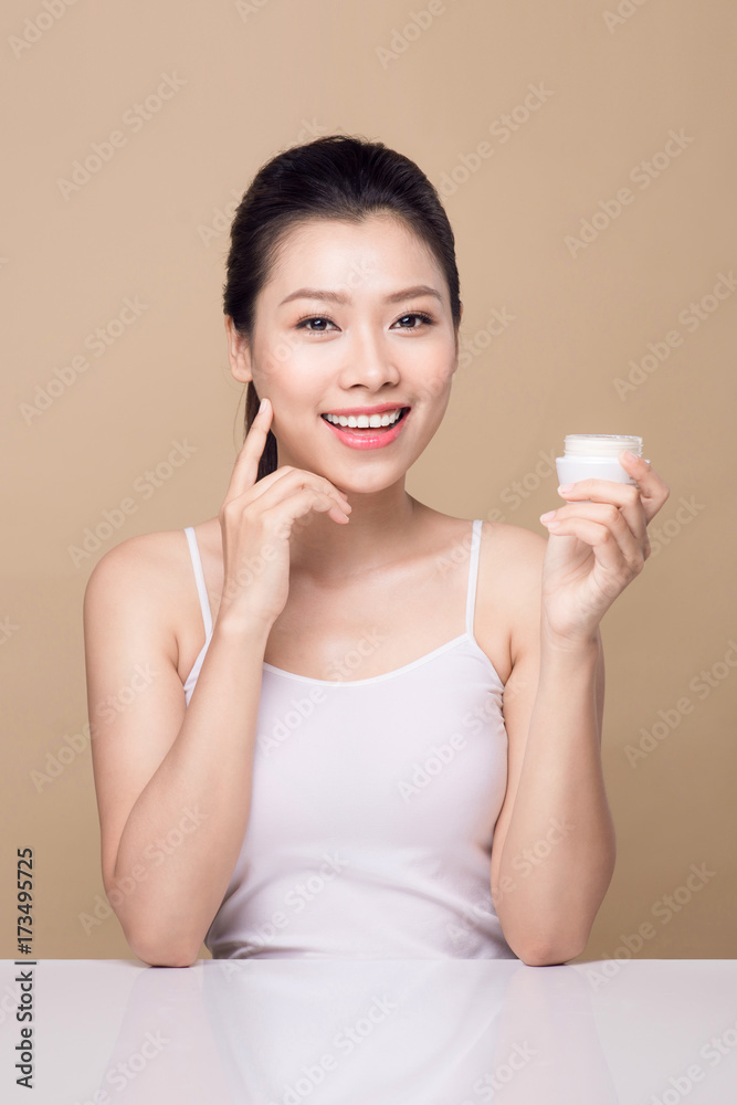 Skincare. Beautiful asian woman show moisturizer or lotion product. Skincare. Beautiful asian woman show moisturizer or lotion product.