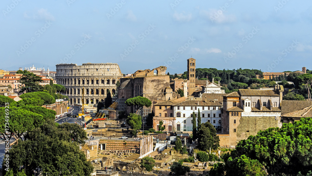 Panoramic view of Rome, Italy with the Colosseum and ruins of the Forum Romanum.