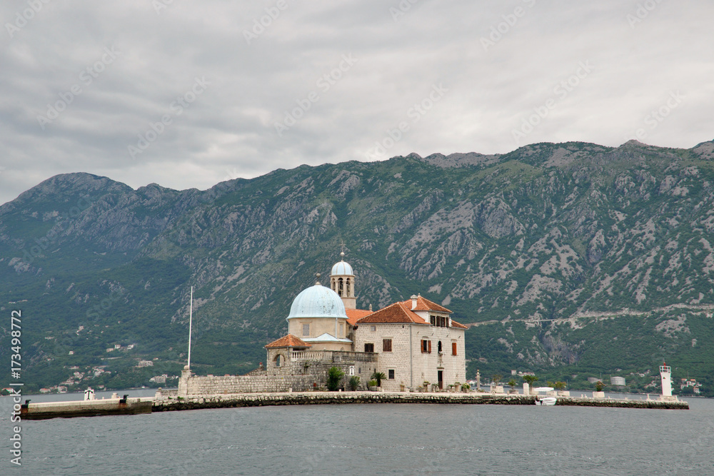 Arrival to the famous Our lady of the reef Island and Church in Kotor Bay of Montenegro