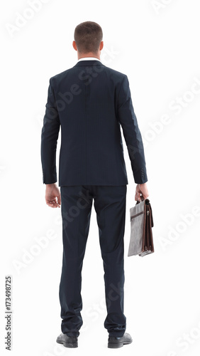 rear view.confident businessman with briefcase