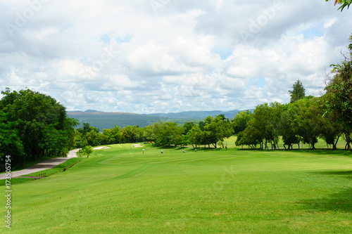 golf course with mountain and blue sky and cloud background