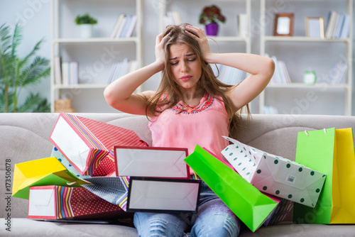Young woman with shopping bags indoors home on sofa