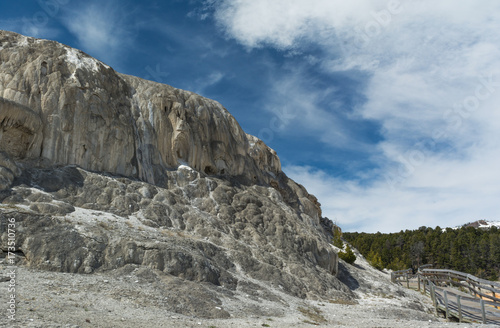 Mineral rock cliff with walkway at Mammoth Hot Springs