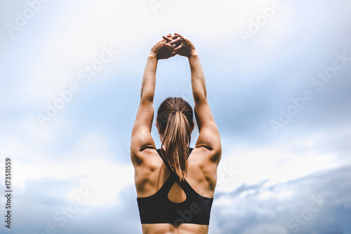 Young woman stretching photo