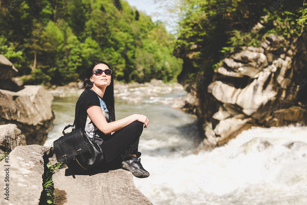 Young tourist girl enjoy nature near mountain river