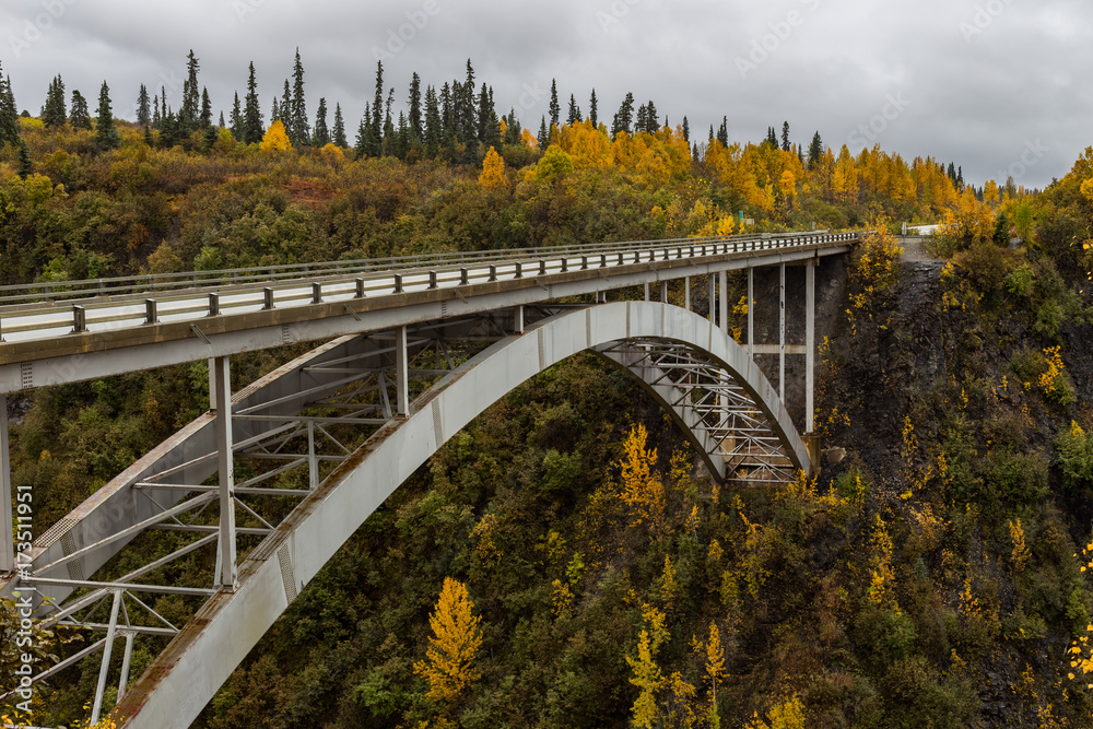 Fall colors surround the bridge over Hurricane Gulch in Alaska. Fall colors surround the bridge over Hurricane Gulch in Alaska.