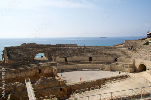 TARRAGONA, SPAIN - AUG 28th, 2017: a panoramic view of the ancient roman amphitheater next to the Mediterranean sea photo