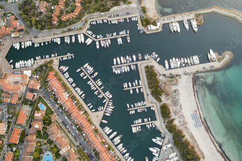 Vista aerea del bellissimo porto Ottiolu in costa smeralda. barche,case e mare immersi nel verde photo