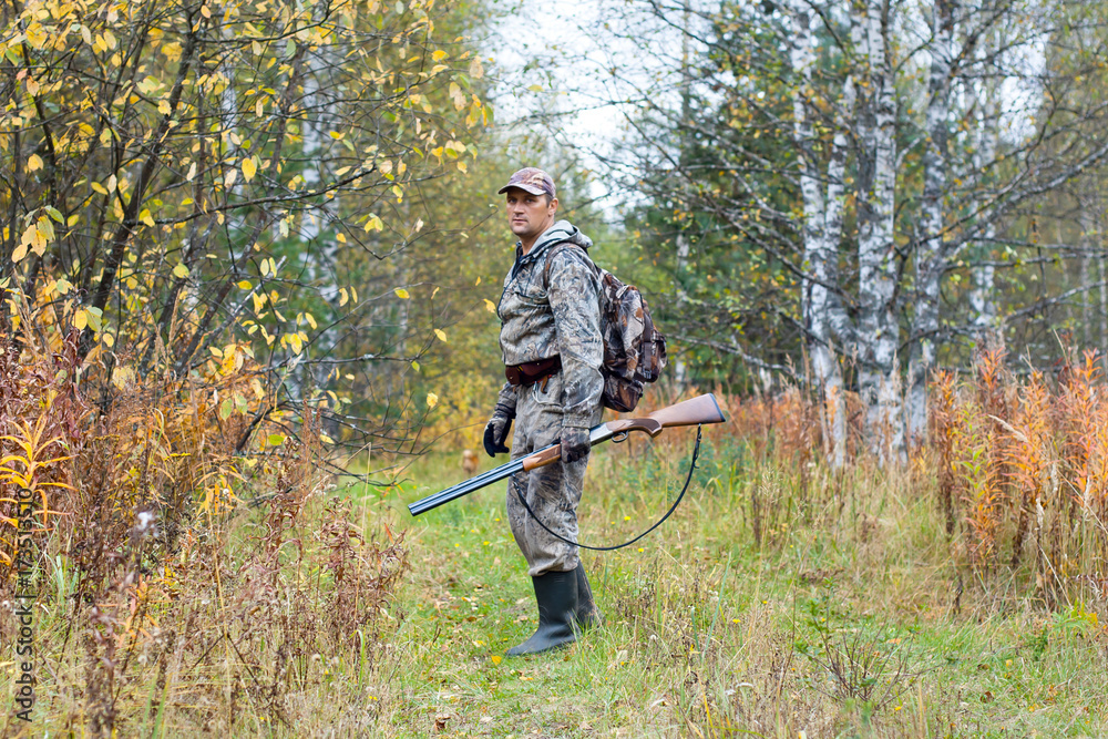 hunter with shotgun on the autumn hunting