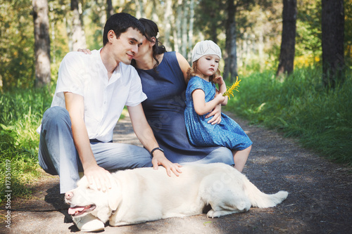 happy family with pet dog at picnic in a Sunny summer day. pregn © olgasparrow