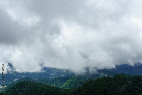 panorama dramatic view of valley with mist over the mountain and cloudy sky background in the morning, Mon Cham Valley, Chiangmai, Thailand.