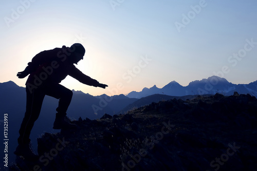 man climbs on the last threshold on the mountain.
