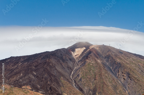 View at Mount Teide Volcano peak covered in clouds and lava formations in Teide National Park in Tenerife © Teresa