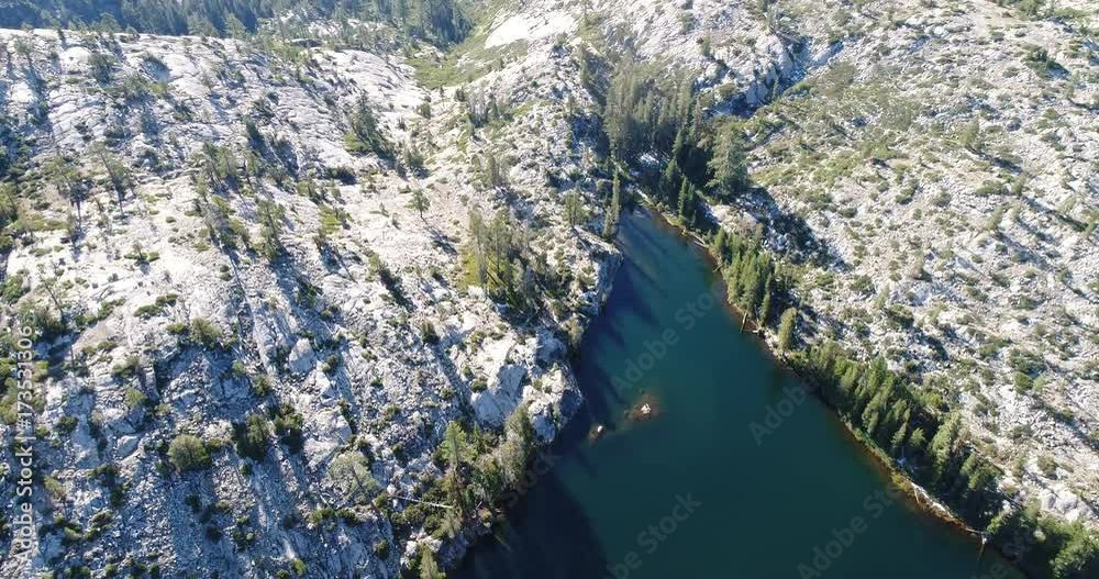 Aerial from over the lake to a camp site Aerial from over the lake to a camp site