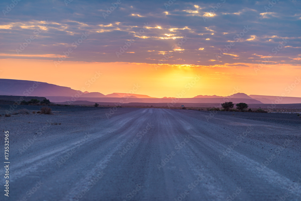 Sunrise over the Namib desert, roadtrip in the wonderful Namib Naukluft National Park, travel destination in Namibia, Africa. Morning light, mist and fog, adventure off road.