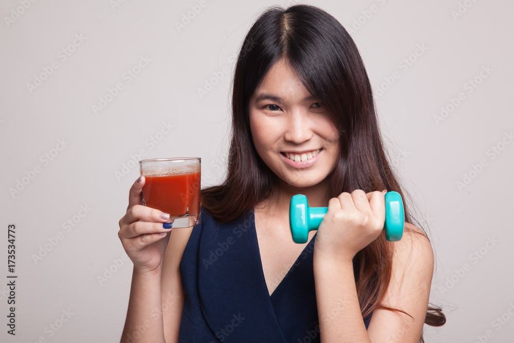 Healthy Asian woman with dumbbell and tomato juice. Healthy Asian woman with dumbbell and tomato juice.