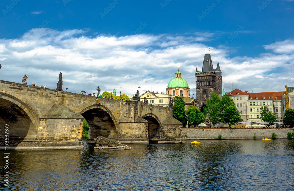Landscape of the romantic city of Prague under a blue sky. Panoramic view of Charles bridge and old town on a summer day in the capital Czech Republic. Cruise on the Moldovan river.