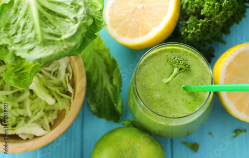 Healthy smoothie with kale in glass on table