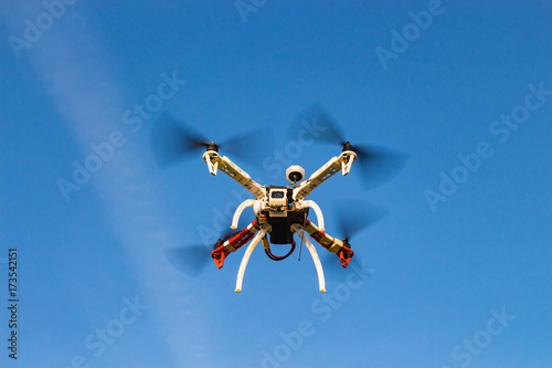 Fototapeta Naklejka Na Ścianę i Meble -  Flying self made rc drone (quadrocopter) with camera, blue sky on background